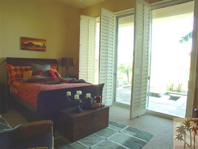 233 Loch Lomond Road Rancho Mirage, CA 92270 - Photo 6 of 16 a bedroom with a bed and a window