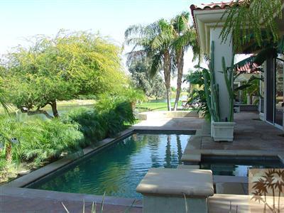 233 Loch Lomond Road Rancho Mirage, CA 92270 - Photo 8 of 16 a view of a patio with table and chairs potted plants with wooden floor and fence