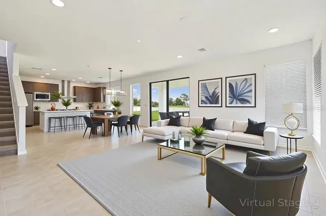 a living room with furniture and kitchen view