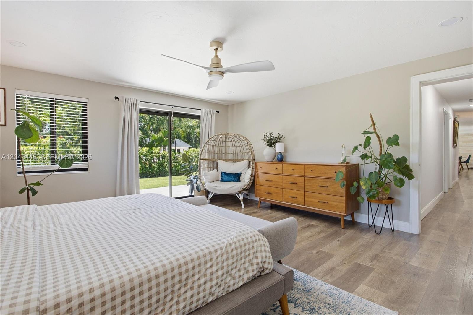 8440 Southwest 180th Street Palmetto Bay, FL 33157 - Photo 21 of 54 a bedroom with a bed a table and chair