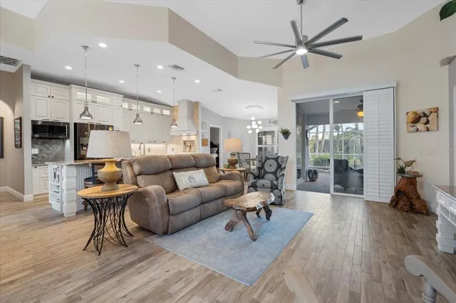 a kitchen with stainless steel appliances a dining table chairs stove and refrigerator