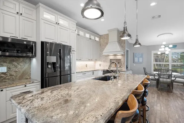 a kitchen with a sink stove and refrigerator