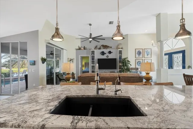 a view of a dining room with furniture a chandelier and wooden floor