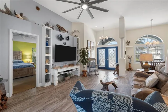 a living room kitchen with furniture and a wooden floor