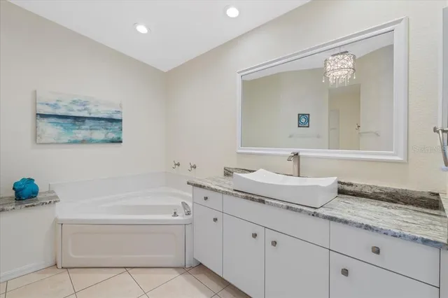 a bathroom with a granite countertop sink a toilet and bathtub