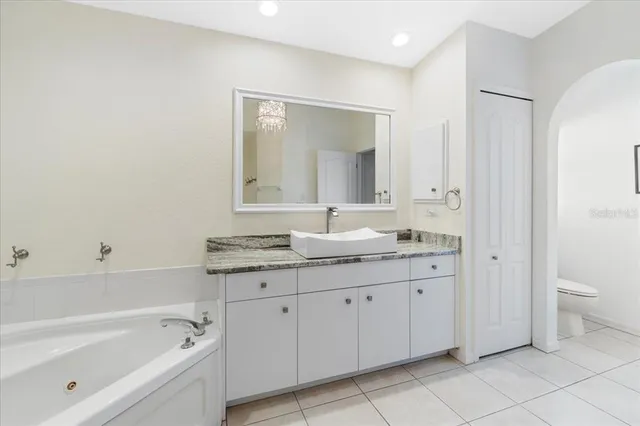 a spacious bedroom with a bed and a table