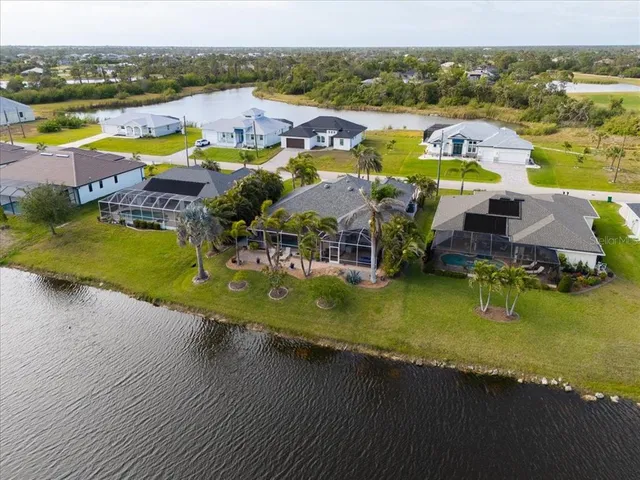 an aerial view of a house with a lake view