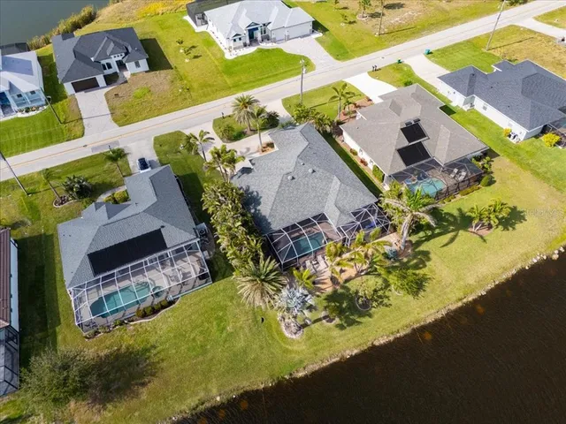 an aerial view of a house with a yard and garden