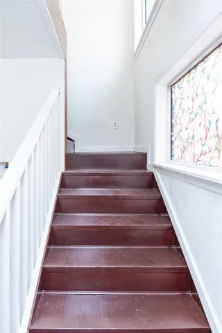 a view of wooden floor and windows in a room