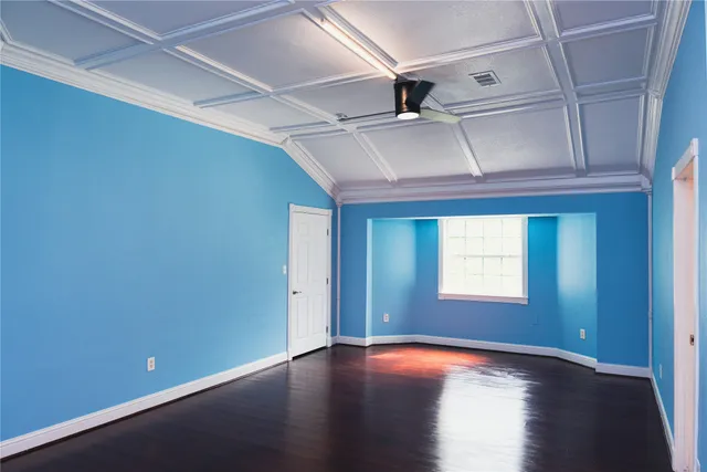 a view of a room with wooden floor and windows
