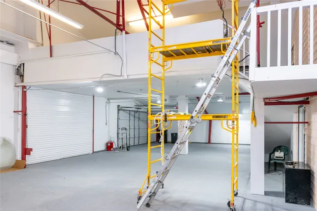 a view of a house with a big yard and large trees