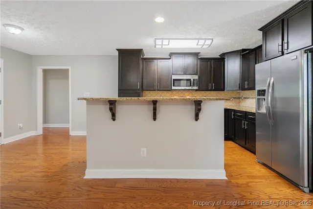 a kitchen with stainless steel appliances a refrigerator and a stove