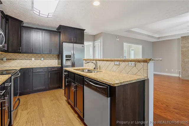 a kitchen with a stove and a refrigerator