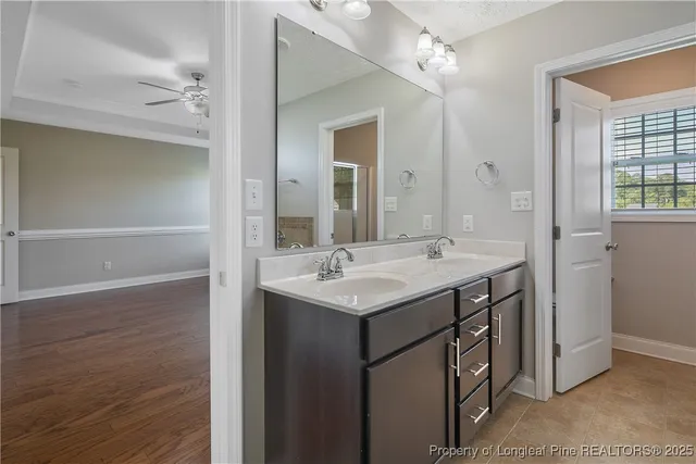 a bathroom with a sink vanity and a mirror