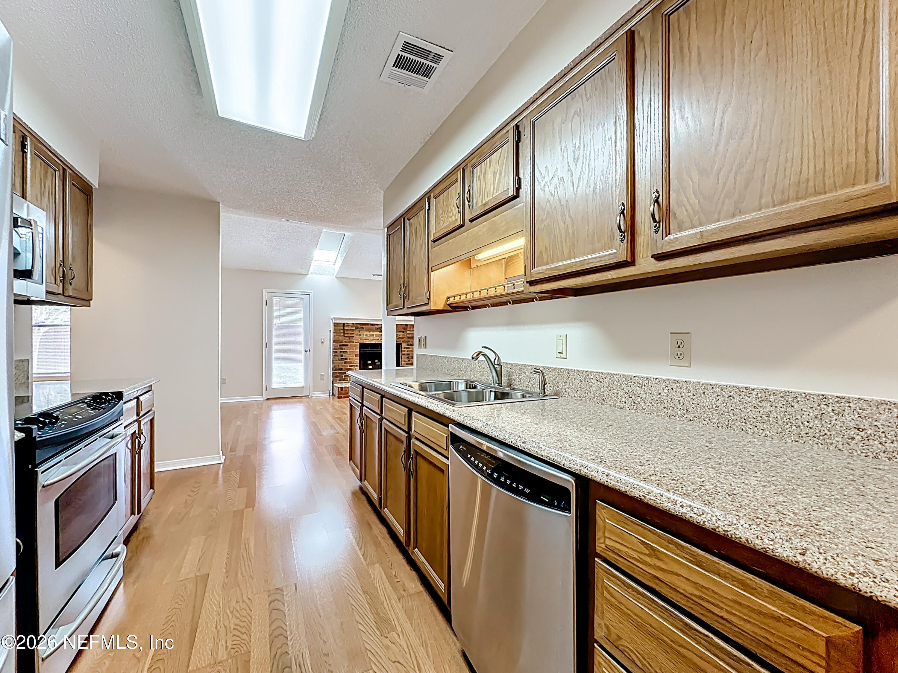 10298 Lone Star Road Jacksonville, FL 32225 - Photo 11 of 42 a kitchen with stainless steel appliances granite countertop a sink stove and cabinets