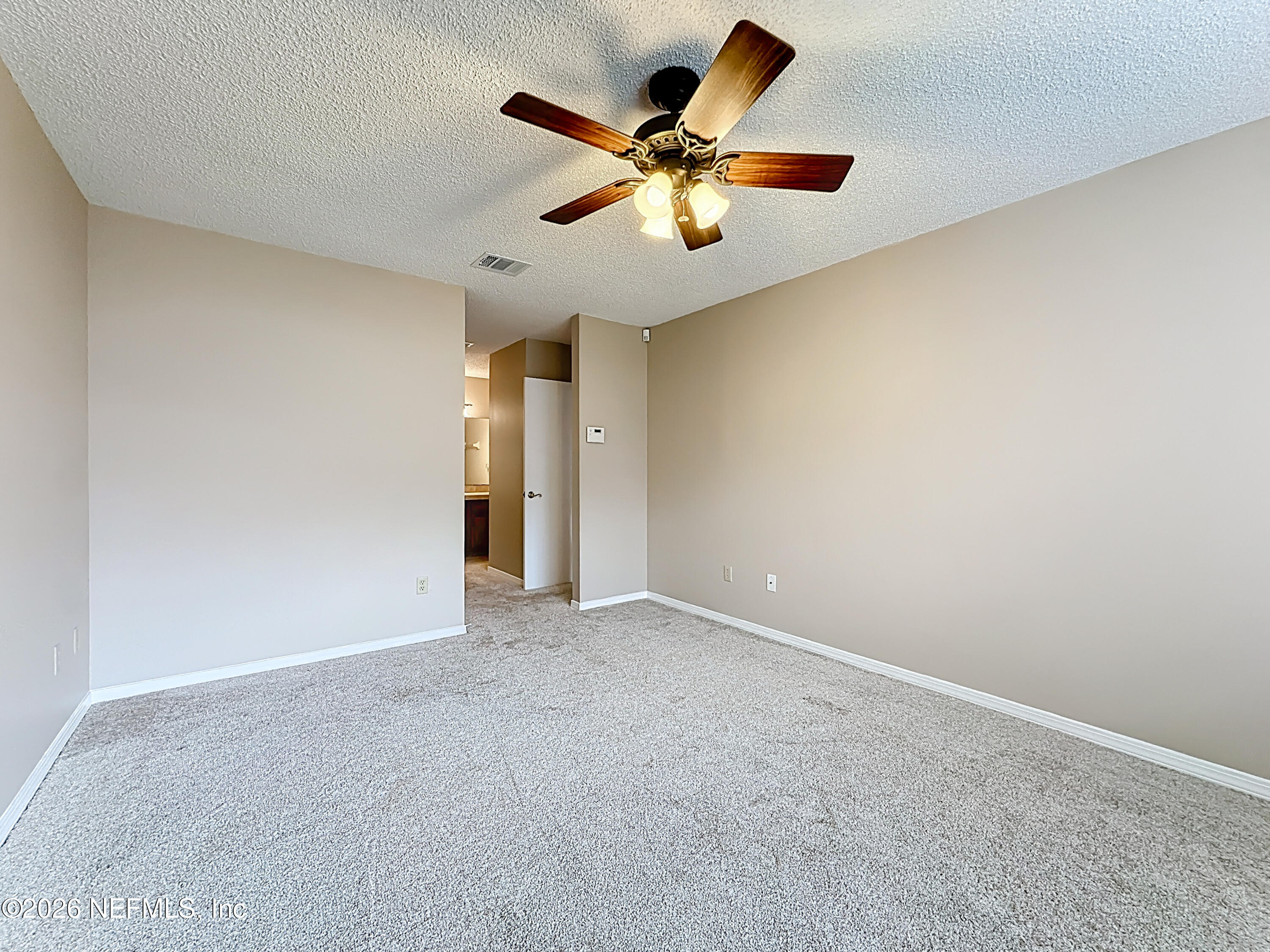 10298 Lone Star Road Jacksonville, FL 32225 - Photo 16 of 42 an empty room with closet and fan