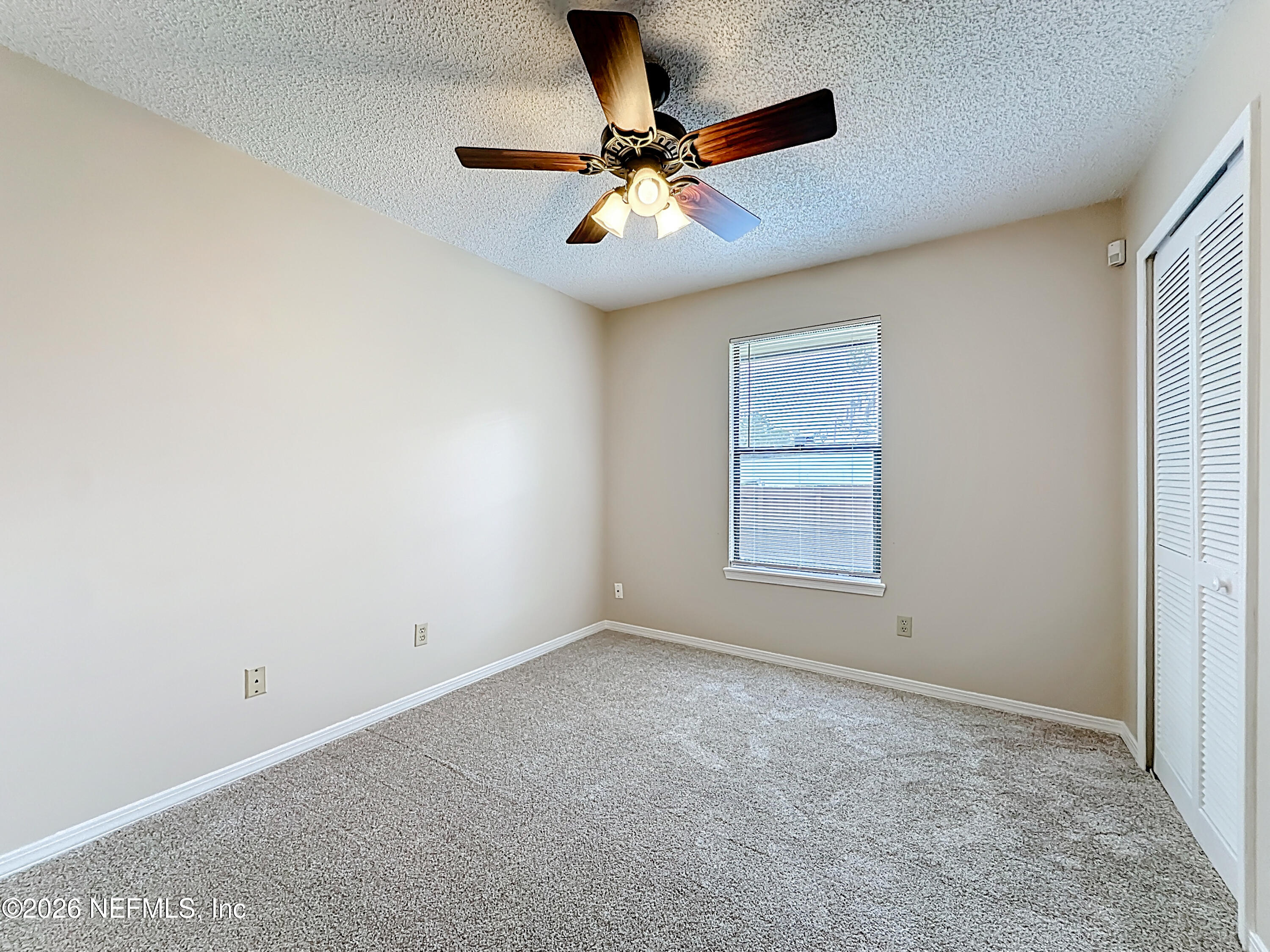 10298 Lone Star Road Jacksonville, FL 32225 - Photo 25 of 42 a view of an empty room with a ceiling fan