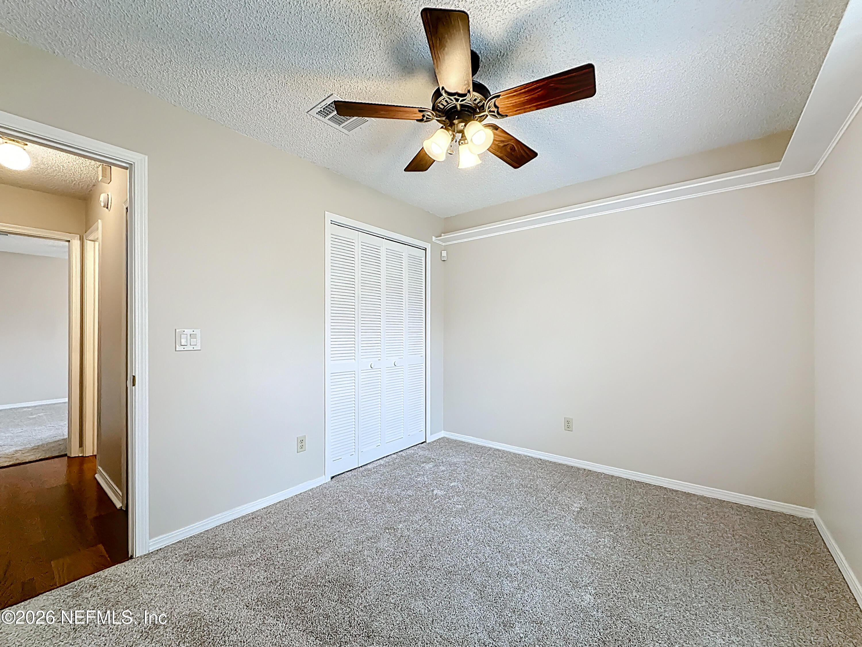 10298 Lone Star Road Jacksonville, FL 32225 - Photo 26 of 42 a view of room with a ceiling fan