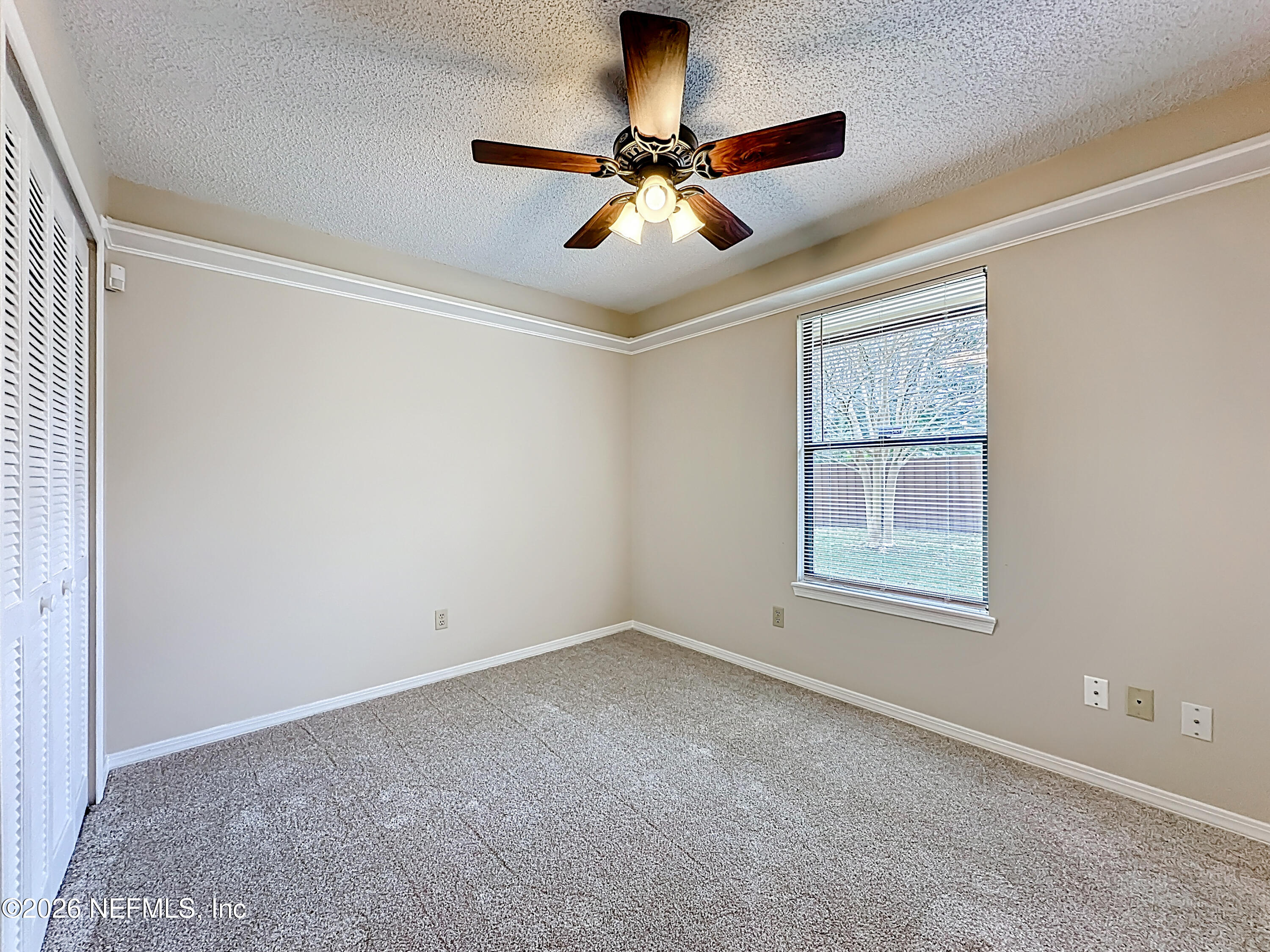 10298 Lone Star Road Jacksonville, FL 32225 - Photo 27 of 42 wooden floor in an empty room with a window