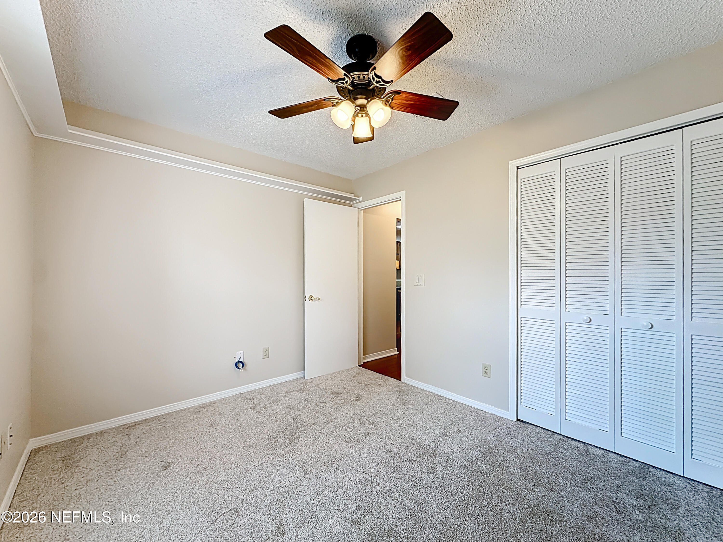 10298 Lone Star Road Jacksonville, FL 32225 - Photo 28 of 42 a view of an empty room with a ceiling fan