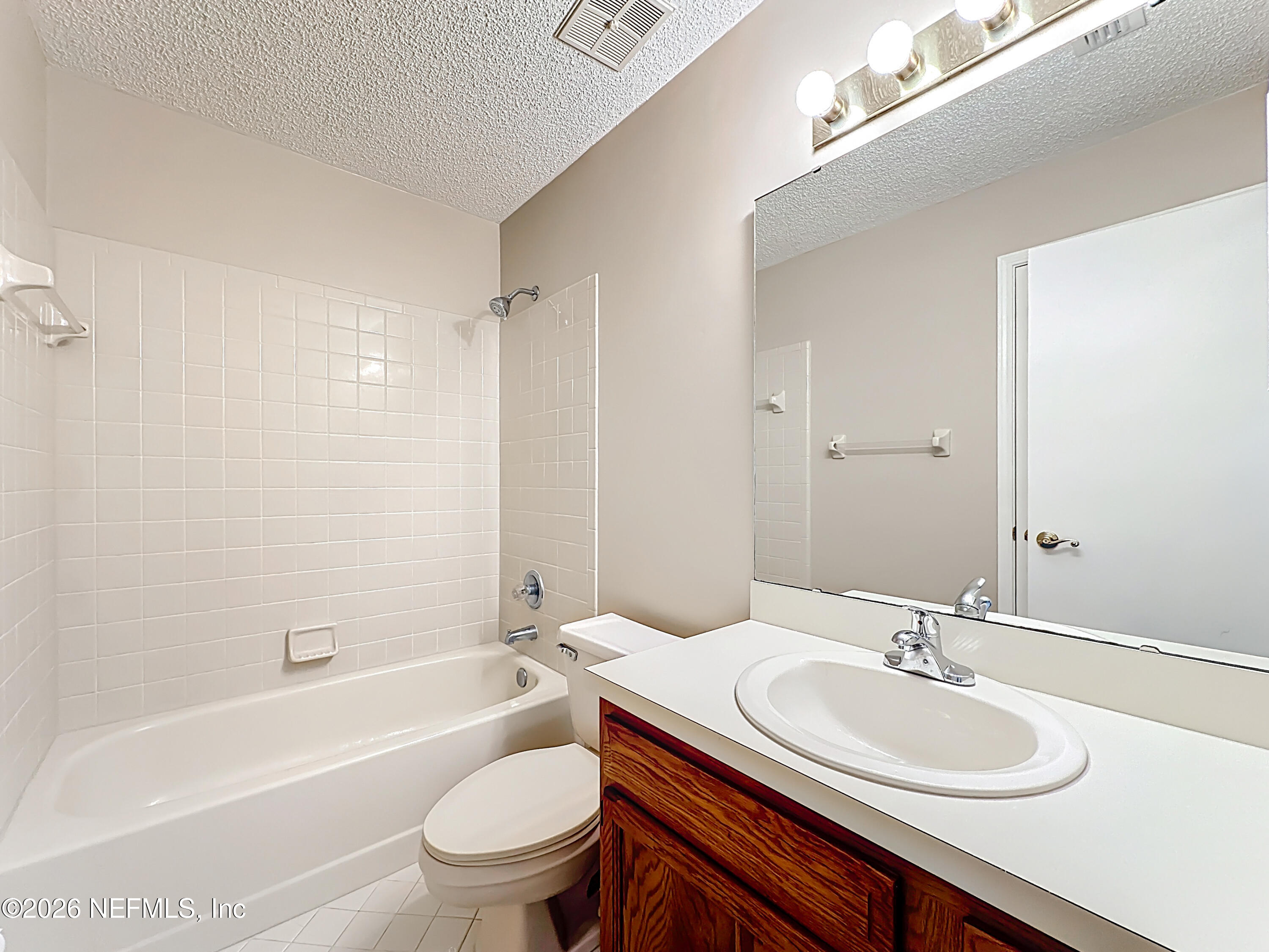 10298 Lone Star Road Jacksonville, FL 32225 - Photo 29 of 42 a bathroom with a sink a toilet and a bathtub
