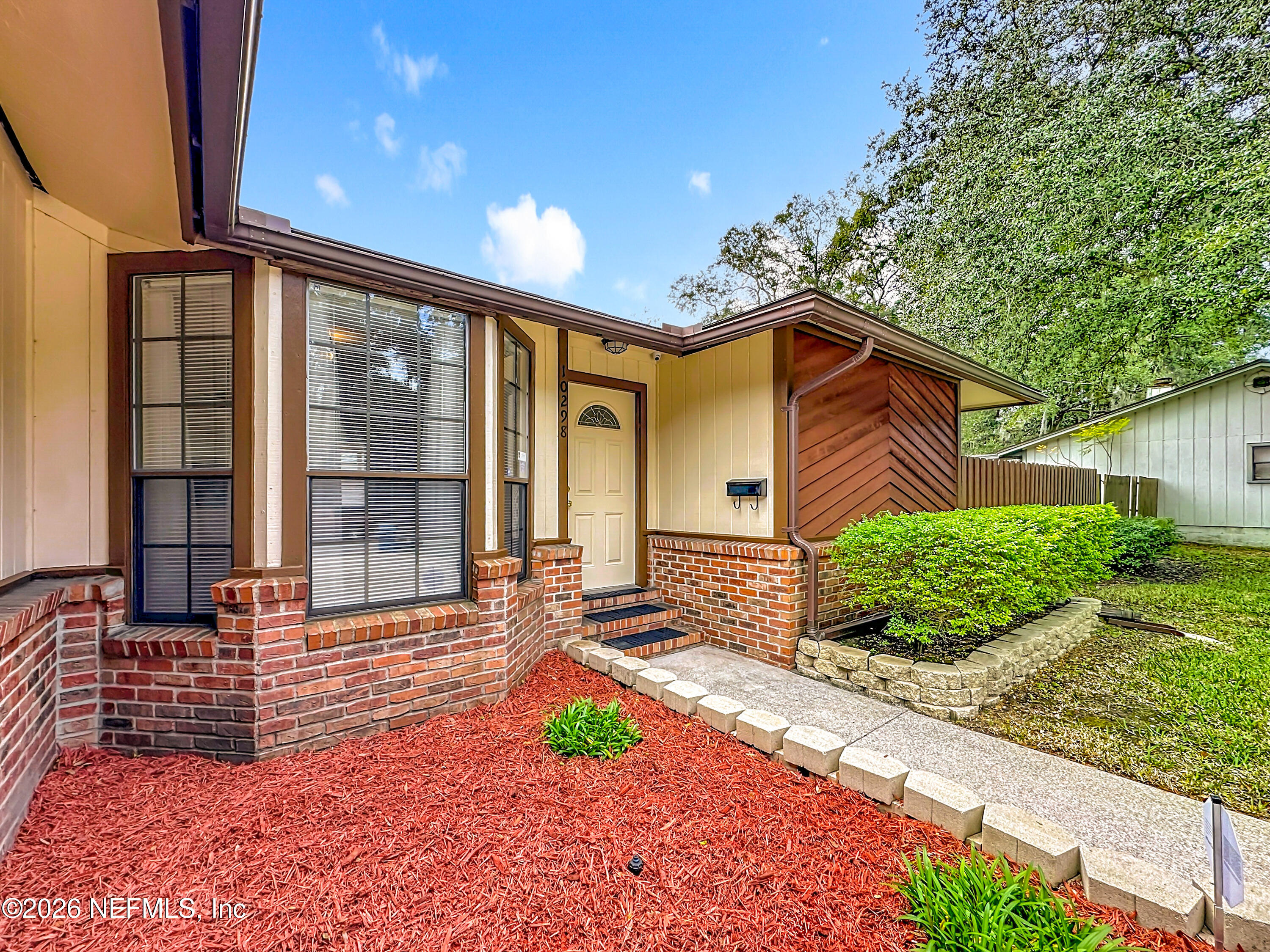 10298 Lone Star Road Jacksonville, FL 32225 - Photo 3 of 42 a front view of a house with garden