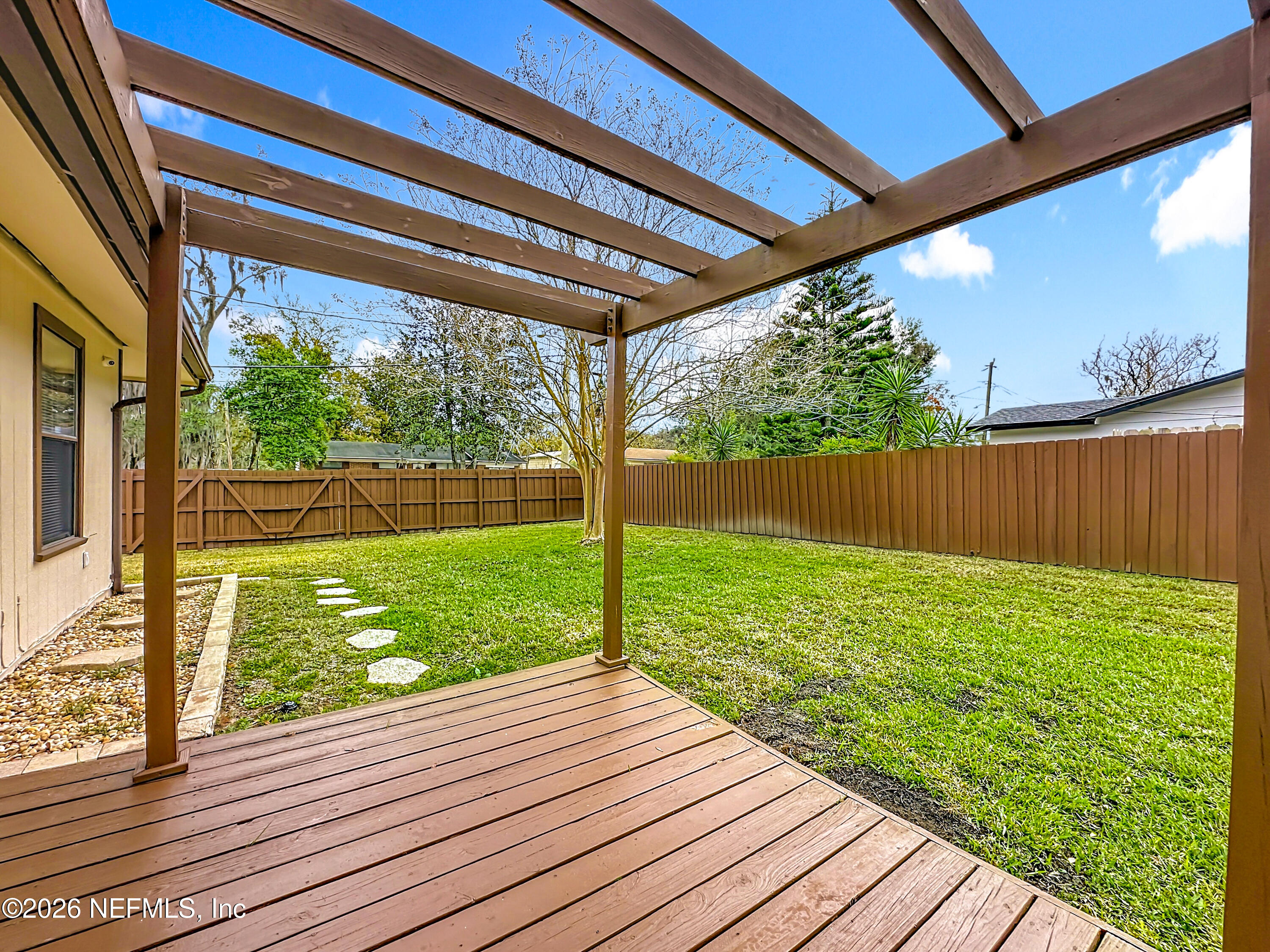 10298 Lone Star Road Jacksonville, FL 32225 - Photo 36 of 42 a view of a yard with wooden deck