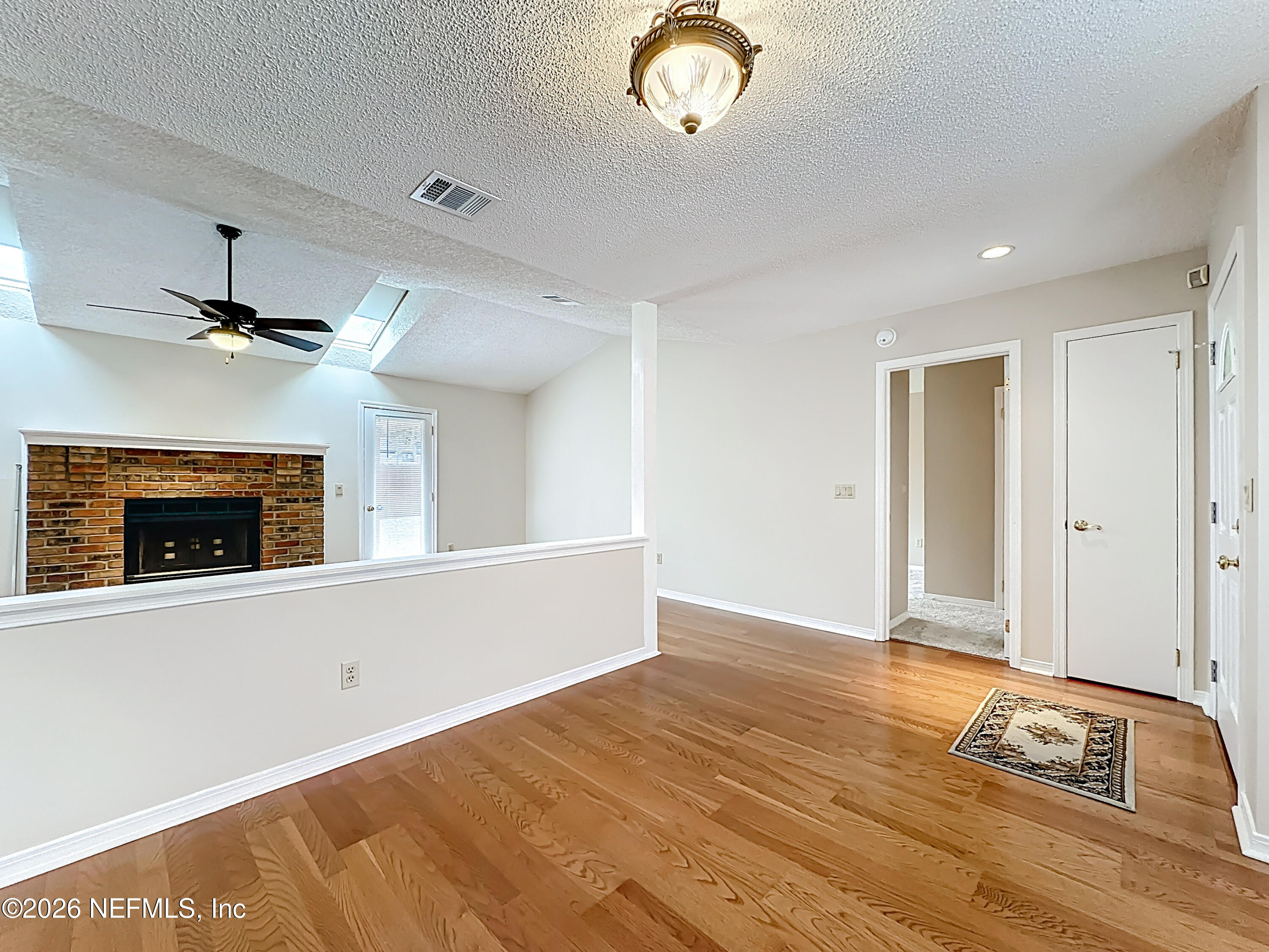 10298 Lone Star Road Jacksonville, FL 32225 - Photo 6 of 42 a view of livingroom with hardwood floor and ceiling fan