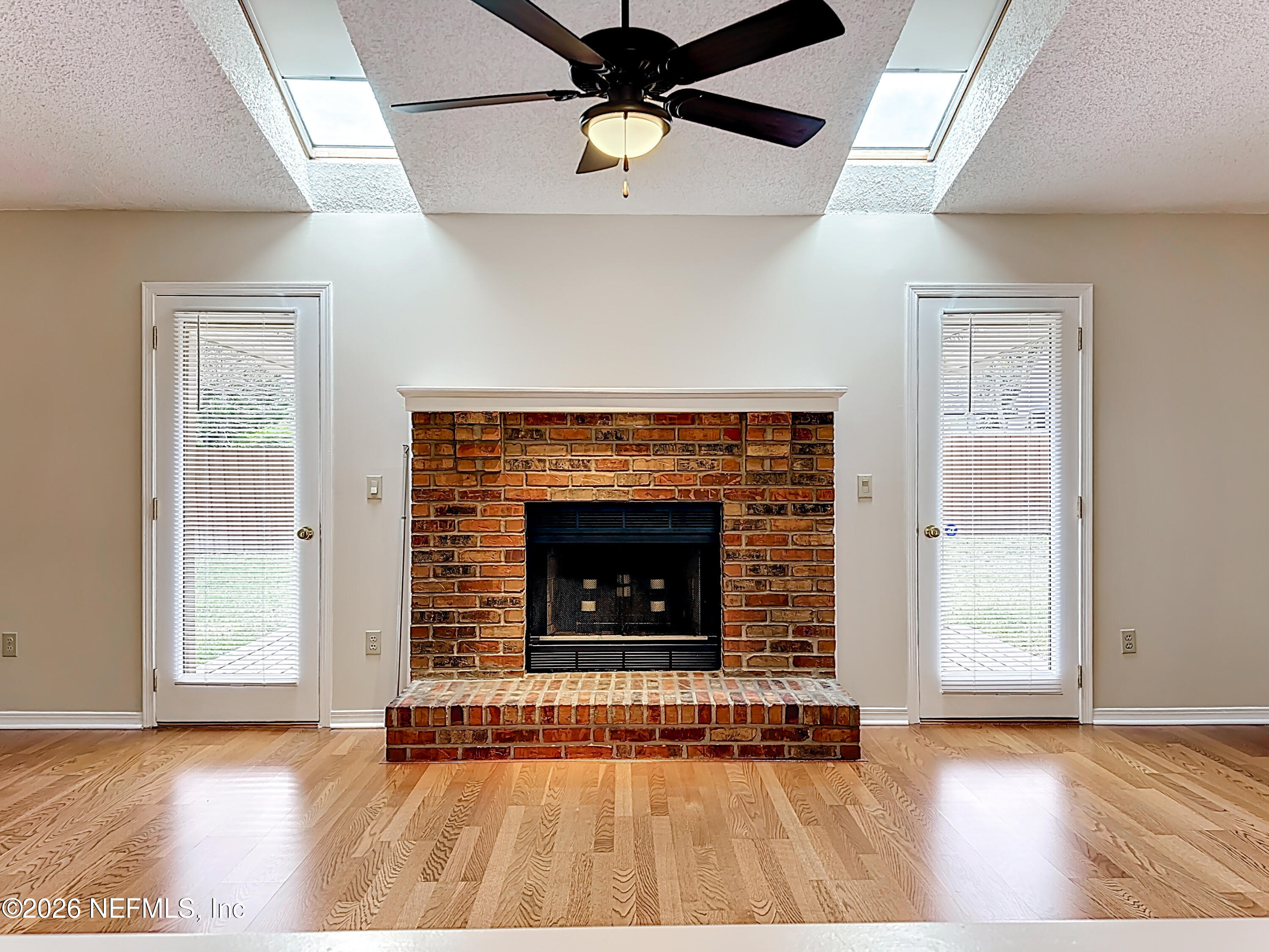 10298 Lone Star Road Jacksonville, FL 32225 - Photo 8 of 42 a living room with fireplace and a wooden floor