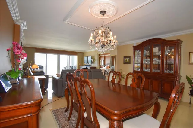 a view of a dining room with furniture and chandelier