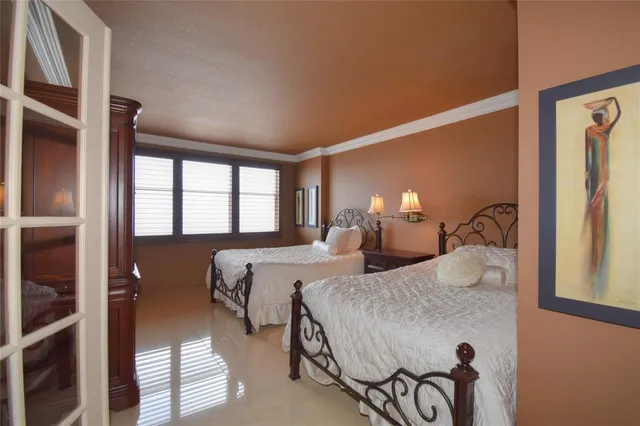 a bedroom with a bed and a lamp