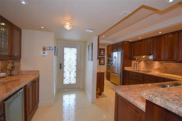 a kitchen with a sink a counter top space and stainless steel appliances