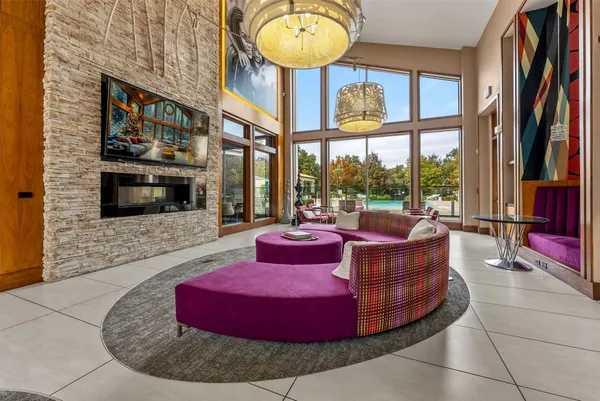 a living room with fireplace furniture and a floor to ceiling window