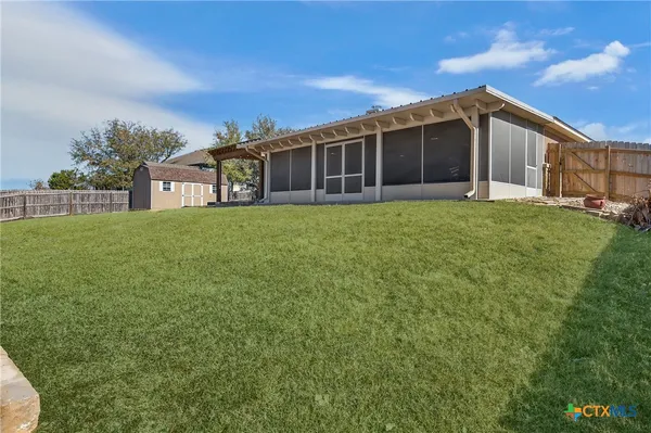 a big house with a big yard and large trees