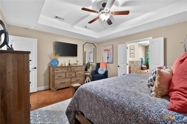 a bed room with a bed window and a flat screen tv
