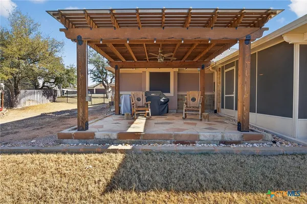 a view of a porch with furniture and a backyard