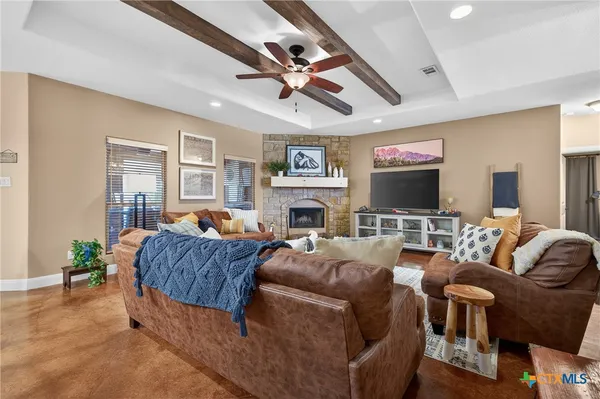 a living room with fireplace furniture and a flat screen tv