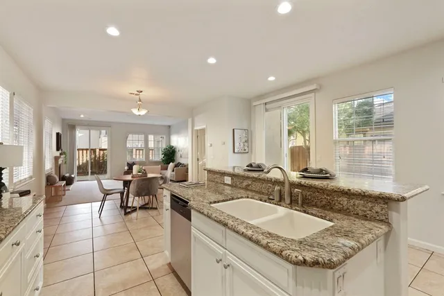 a large kitchen with granite countertop a sink and a granite counter tops
