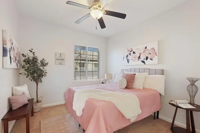 a bedroom with a large bed and a chandelier
