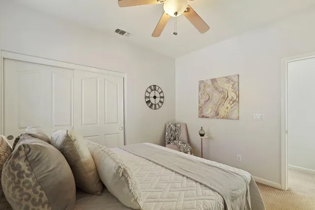 a bedroom with a bed and lamp