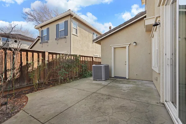 a view of a house with a wooden fence
