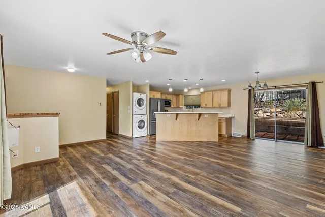 a view of a kitchen with wooden floor and a ceiling fan