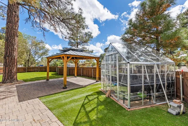 a view of a backyard with a swimming pool