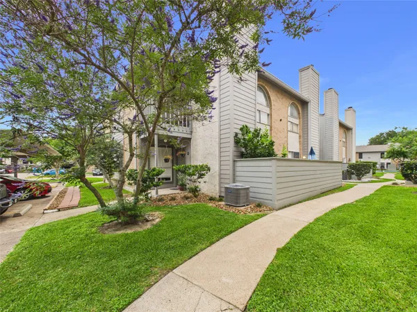 a view of a house with backyard sitting area and garden