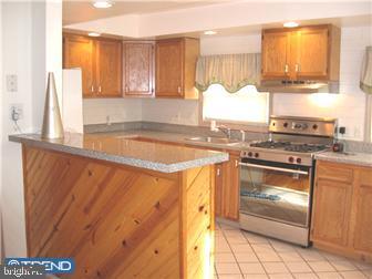 229 Ballymore Road Springfield, PA 19064 - Photo 4 of 12 a kitchen with granite countertop a sink and a stove