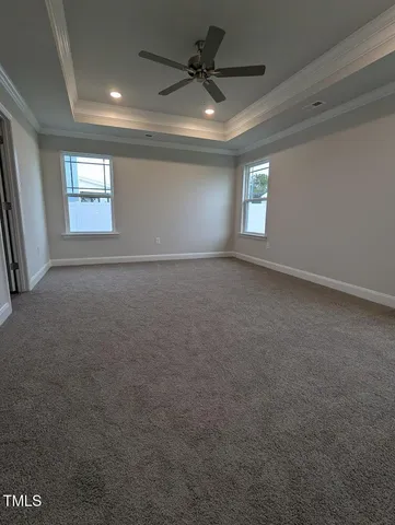 a view of a room with wooden floor and windows