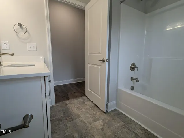 a bathroom with a sink a toilet and a window