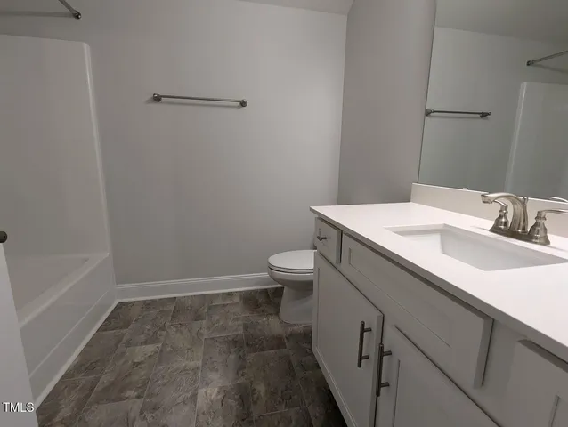 a bathroom with a bathtub sink and vanity