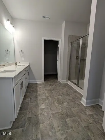 a bathroom with a glass shower door