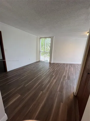 a view of an empty room and wooden floor